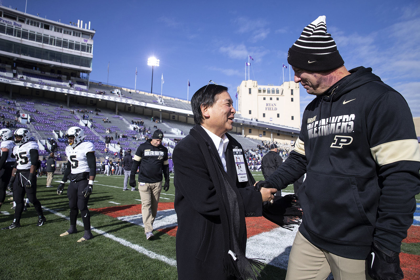Glenn Sugiyama, managing partner of DHR International executive search firm, greets Purdue coach Jeff Brohm before the Purdue-Northwestern game on Nov. 9 in Evanston, Illinois.